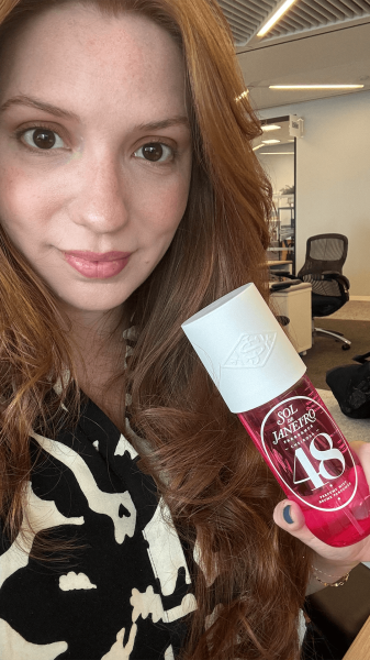 Allure social media director Kassidy Silva holding a bottle of the Sol de Janeiro Cheirosa 48 Perfume Mist.